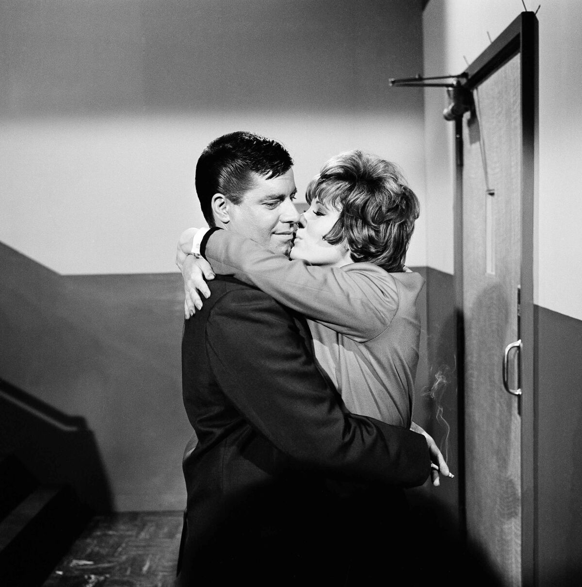 Jerry Lewis embraces and kisses Jill St. John in the 1963 movie 'Who's Minding the Store'