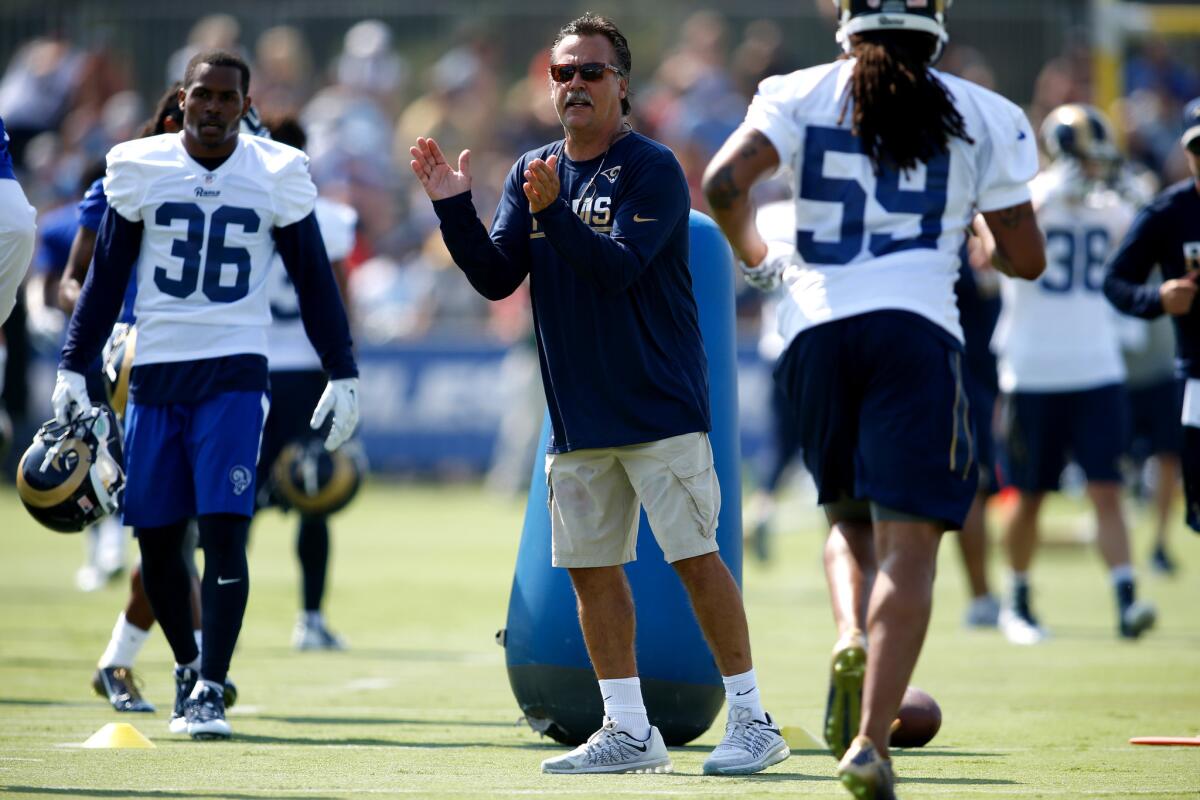 Rams Coach Jeff Fisher offers encouragement during the first day of training camp at UC Irvine on July 30.