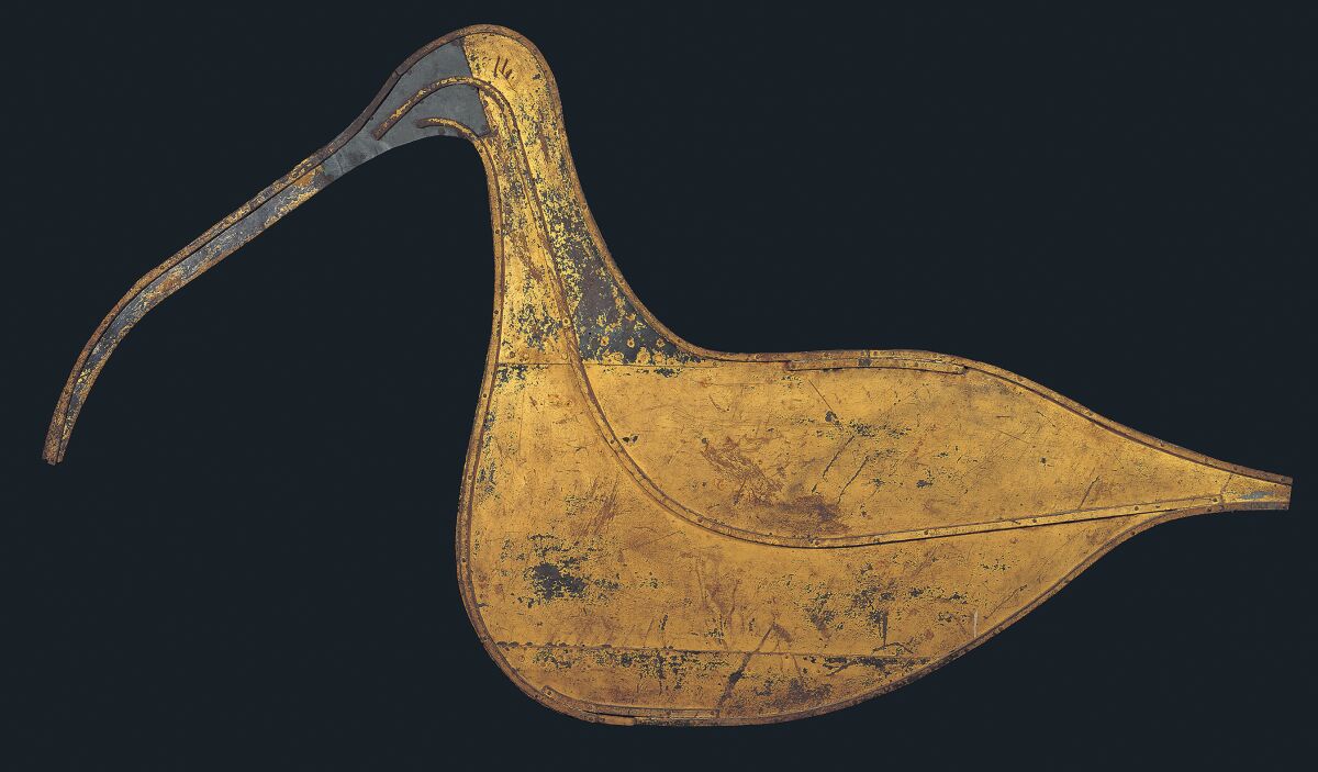 This image provided by the American Folk Art Museum shows the Hudsonian Curlew weather vane. The museum's curator, Emelie Gevalt, said one of her favorite pieces in the exhibit is the museum's own "Hudsonian Curlew." The 1874 piece is large, nearly 7 feet tall and 4 feet wide. A relatively simple design, it depicts the body and distinctive curved beak of the shorebird in gold-leafed sheet metal, and once sat atop the Curlew Bay sportsmen's club in Seaville, New Jersey. (John Bigelow Taylor/American Folk Art Museum via AP)
