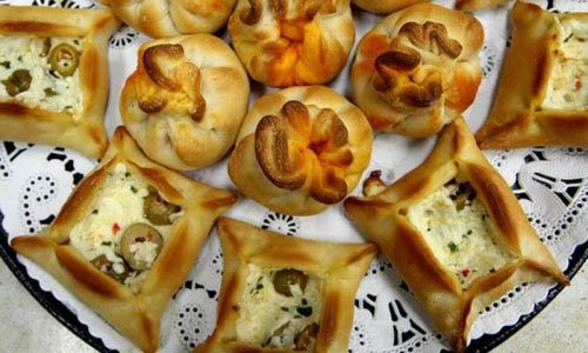 Potato Mushroom Puffs (round) and olive cheese bureks (square) are for sale at the Zaatar Factory and Bakery.