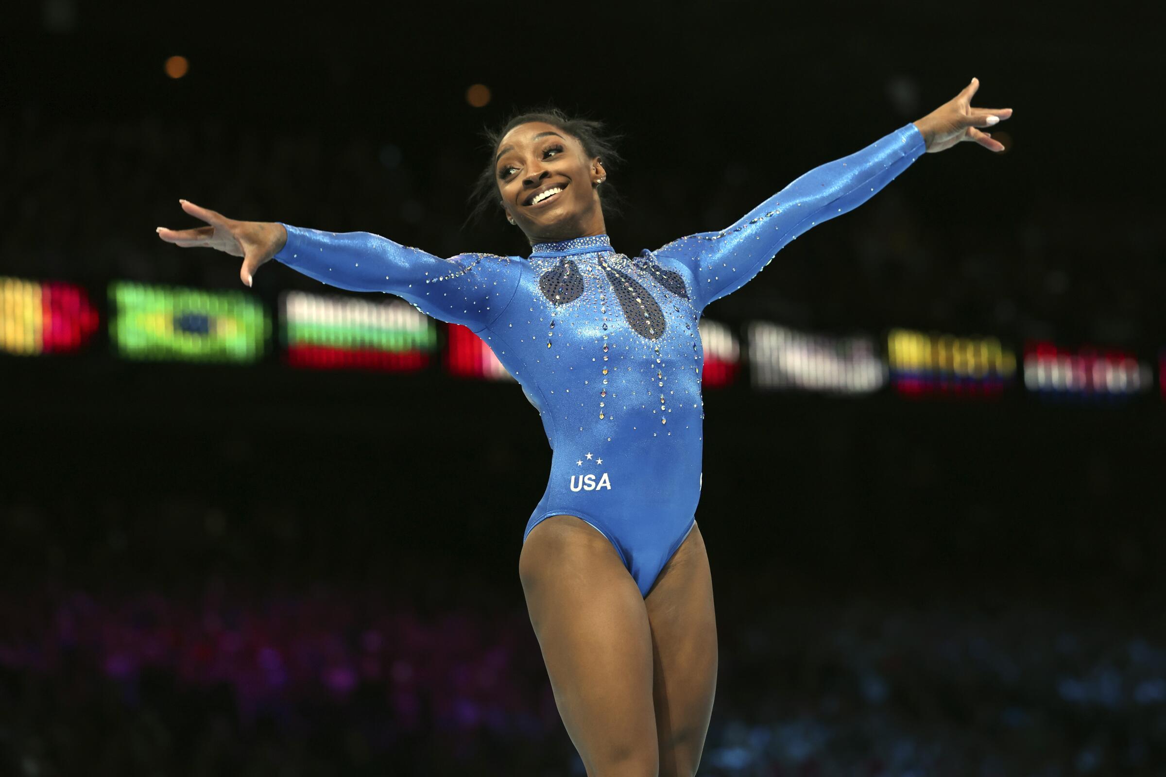 Simone Biles celebrates after winning gold in the women's all-around final at the gymnastics world championships in Belgium.