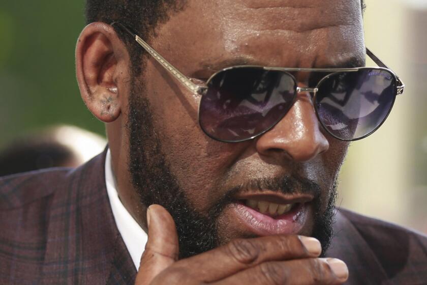 FILE - This photo from Wednesday June 26, 2019, shows R&B singer R. Kelly arriving at the Leighton Criminal Court in Chicago for arraignment on sex-related charges. Federal prosecutors in New York on Friday, July 23, 2021 asked a judge for permission to admit more evidence for which Kelly has not been charged, at his upcoming sex-trafficking trial in Brooklyn. (AP Photo/Amr Alfiky, File)