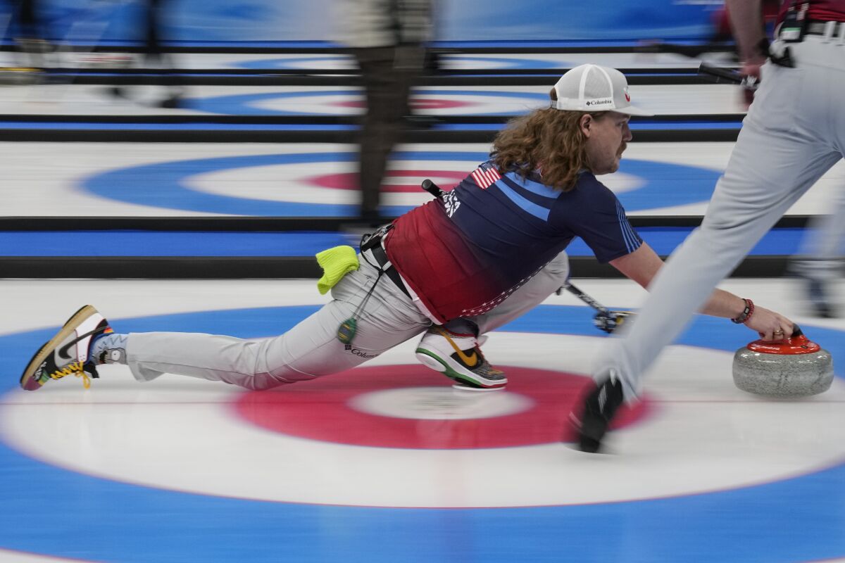 The United States' Matt Hamilton throws a stone during a men's curling match against Sweden at the Beijing Winter Olympics Thursday, Feb. 10, 2022, in Beijing. (AP Photo/Brynn Anderson)
