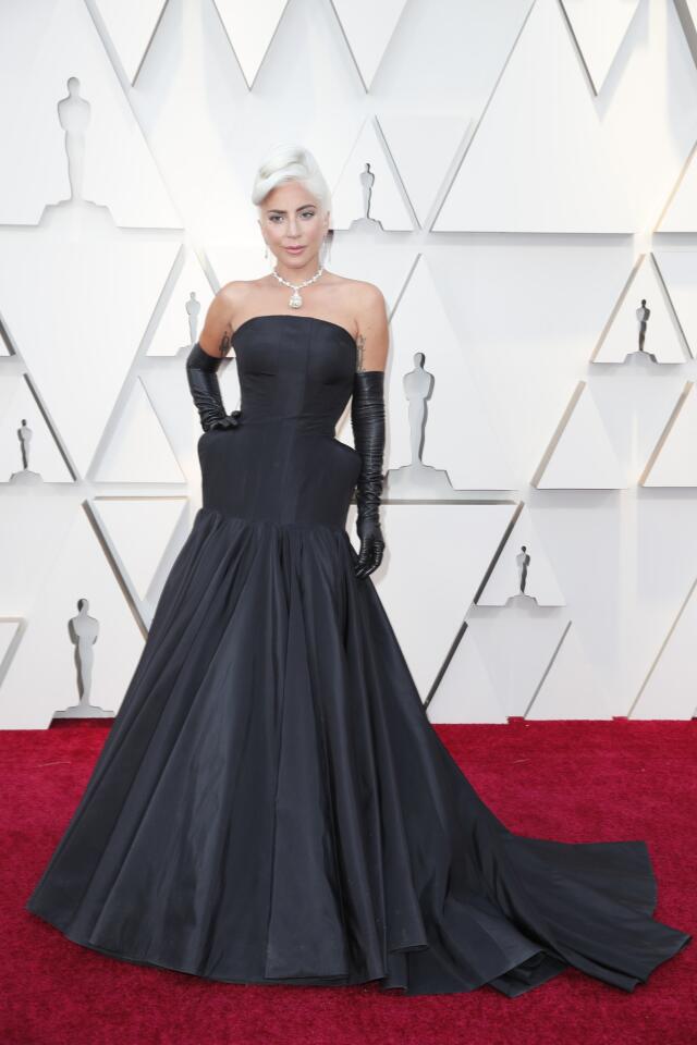 HIT: Lady Gaga completes her season-long red-carpet fashion winning streak in a dreamy, "mistress of the dark" gown by Alexander McQueen with long leather gloves and a 128-carat diamond necklace from Tiffany & Co.