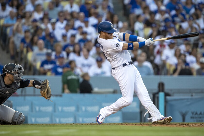 The Dodgers' Justin Turner hits a three-run homer in the third inning Aug. 20, 2022. Marlins catcher Nick Fortes is at left.