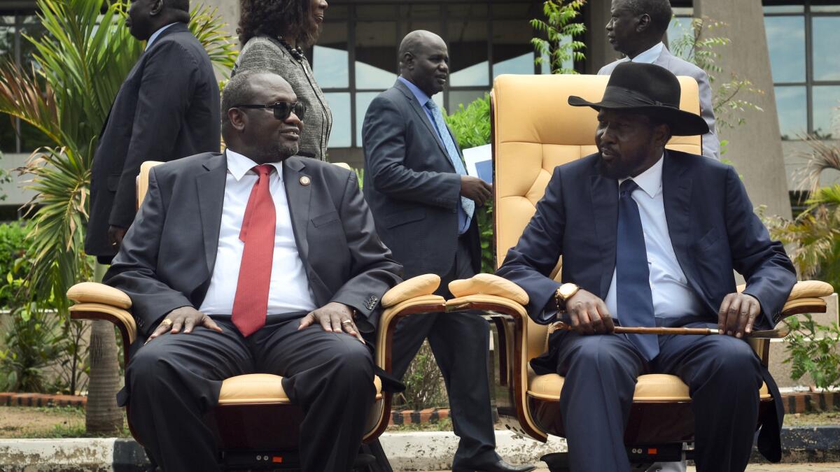 Riek Machar, left, who was South Sudan's first vice president, and President Salva Kiir attend the first meeting of a new transitional coalition government in the capital, Juba, on April 29, 2016.