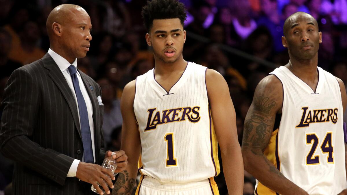 Lakers Coach Byron Scott talks to rookie guard D'Angelo Russell with Kobe Bryant nearby during a game Nov. 1.