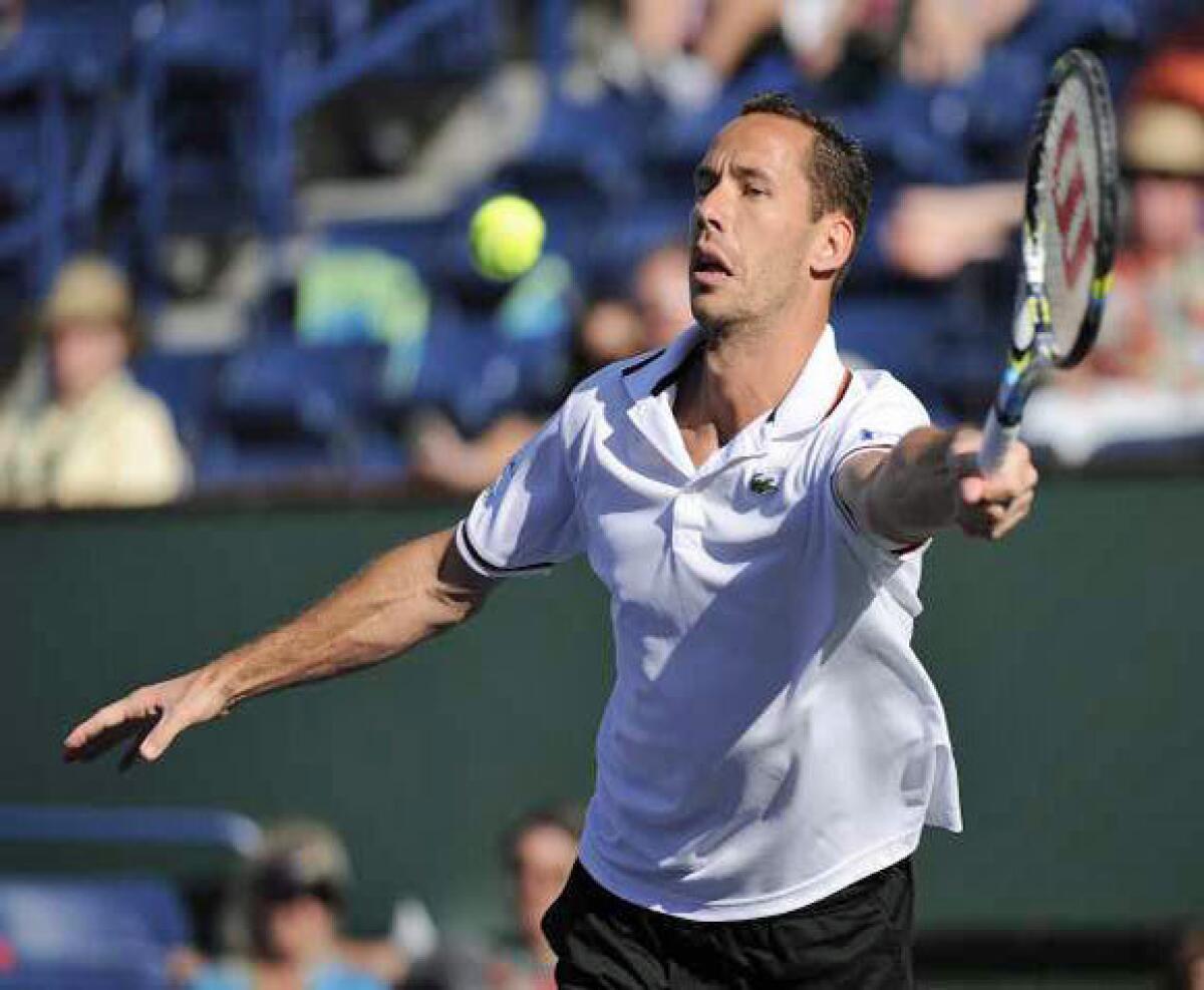 Michael Llodra hits a return against Jo-Wilfried Tsonga on Tuesday. Llodra retired from the match due to a leg injury, perhaps from sticking his foot in his mouth.
