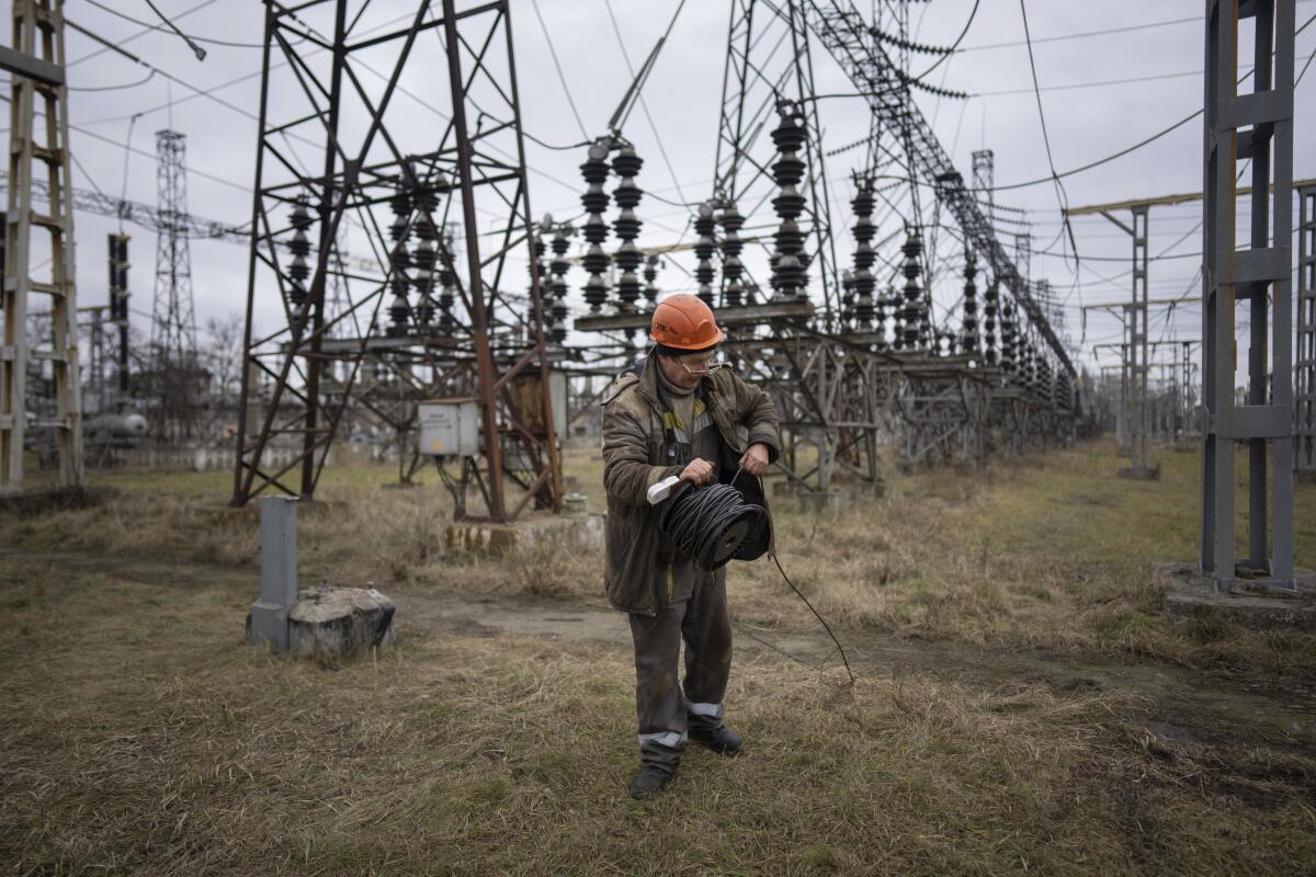 FILE - A worker at a power plant, tries to repair damages after a Russian attack in central Ukraine, Jan. 5, 2023. The Biden administration will provide $125 million for parts and other supplies to help repair crews in Ukraine keep up with Russian strikes pounding the country’s electrical system. U.S. international development aid chief Samantha Power announced the funding in a statement Wednesday. (AP Photo/Evgeniy Maloletka, File)