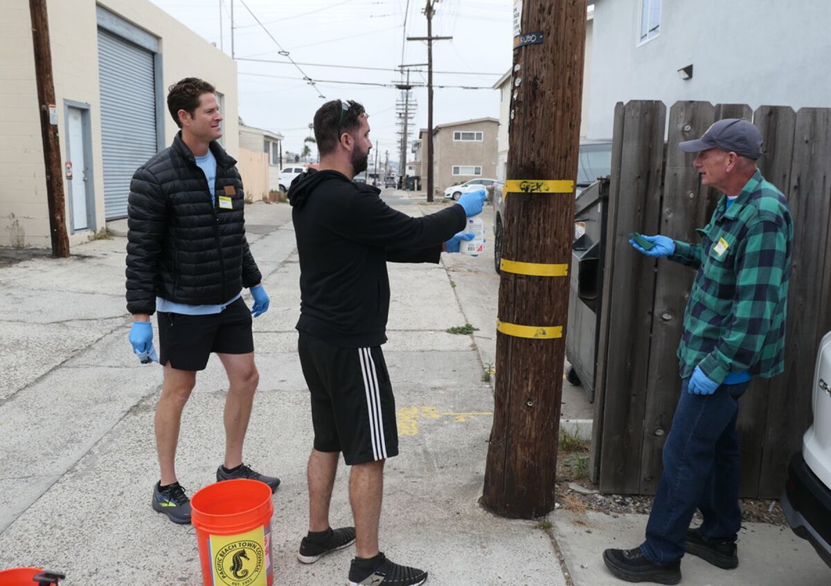 Trevor Gamble, Arash Bahar and Ed Maxwell were among graffiti removal volunteers.