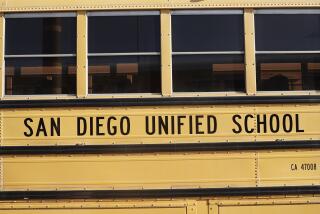 San Diego Unified School District signage is seen on a Navistar International Corp. school bus at the San Diego Unified School District Transportation Department in San Diego, California, U.S., on Thursday, July 9, 2020. The U.S. economy is caught in the middle of President Trump's tug-of-war to reopen schools -- and could end up damned no matter what happens. Photographer: Bing Guan/Bloomberg via Getty Images