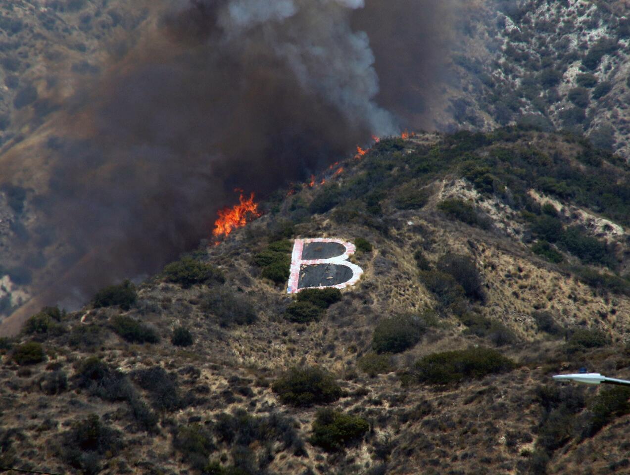 Burbank firefighters fought a three-alarm brush fire above Wildwood Canyon Park on Saturday.