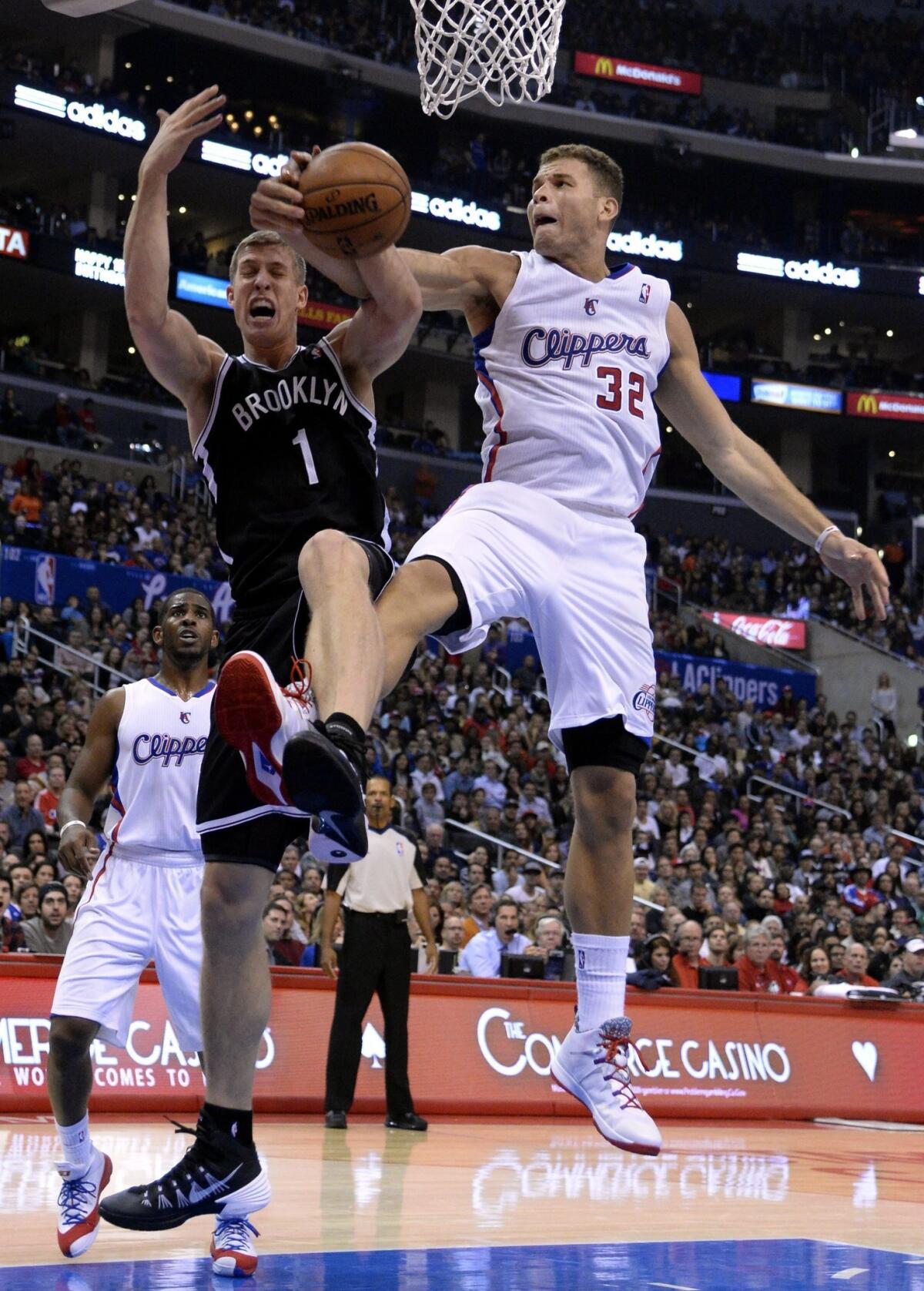 Clippers forward Blake Griffin, right, battles Brooklyn Nets forward Mason Plumlee for the ball during the Clippers' 110-103 win Saturday night at Staples Center.