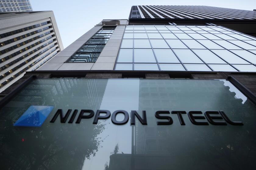 FILE - Nippon Steel Corporation's logo is displayed on a sign outside its headquarters in Tokyo on Nov. 26, 2021. Nippon Steel said Friday, May 3, 2024, it has postponed the expected closing of its $14.1 billion takeover of U.S. Steel by three months after the U.S. Department of Justice requested more documentation related to the deal. (AP Photo/Hiro Komae, File)