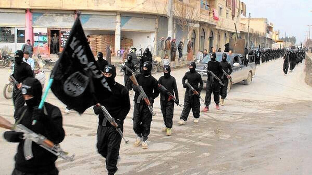 Islamic State fighters march in Raqqah, Syria, in an undated image.
