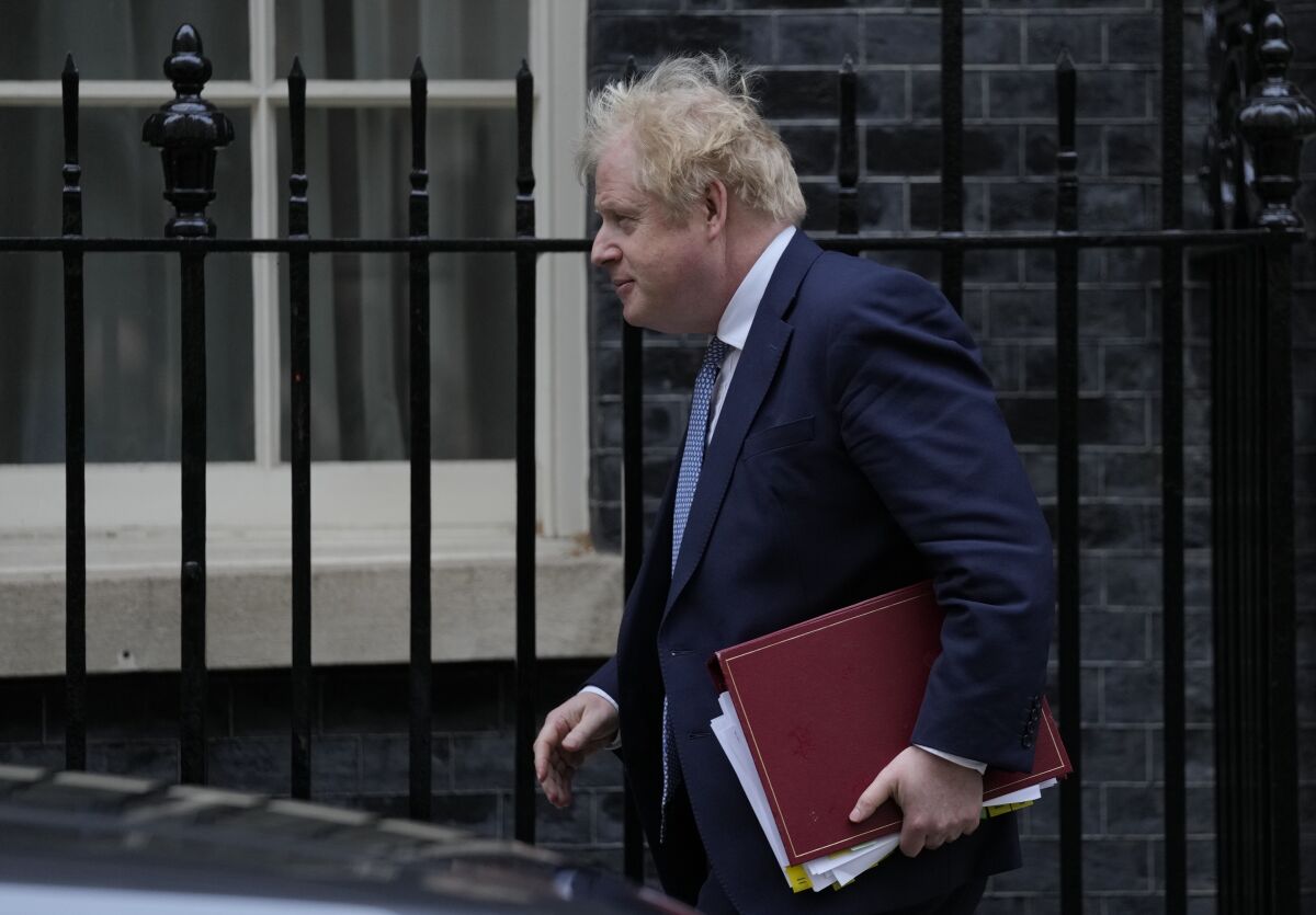 Britain's Prime Minister Boris Johnson leaves 10 Downing Street for the House of Commons for his weekly Prime Minister's Questions in London, Wednesday, Feb. 2, 2022. (AP Photo/Alastair Grant)