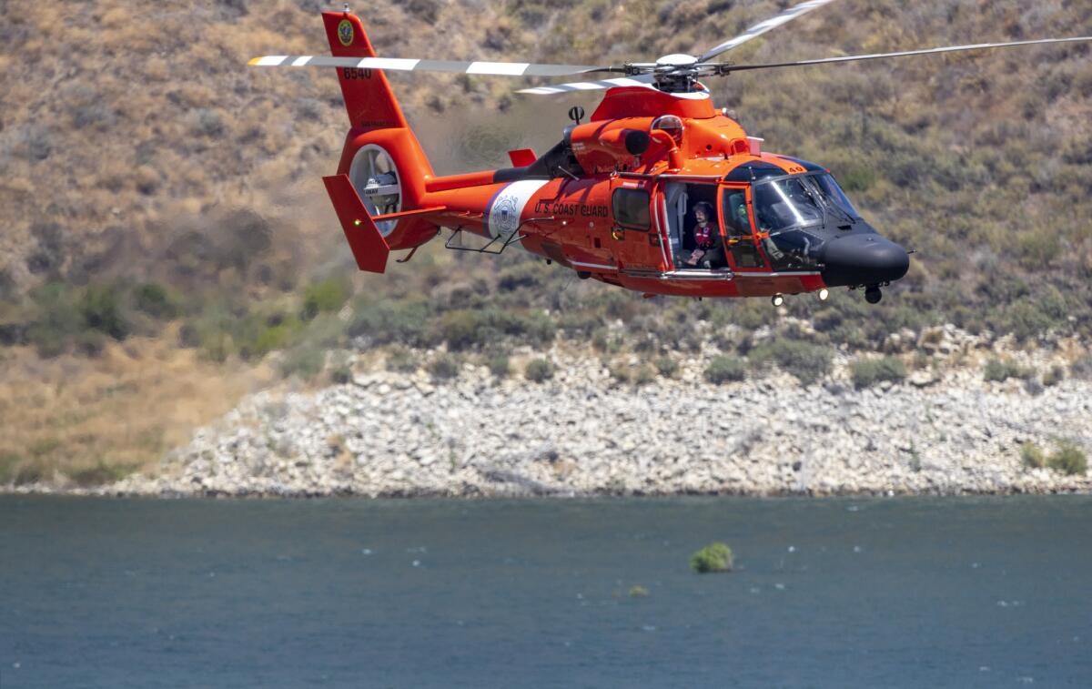 A Coast Guard helicopter assisting in the search for Naya Rivera flies over Lake Piru on Thursday.