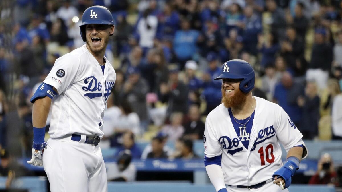 Dodgers' Cody Bellinger, left, celebrates his two-run home run with teammate Justin Turner during the first inning against the Pittsburgh Pirates on Friday at Dodger Stadium.