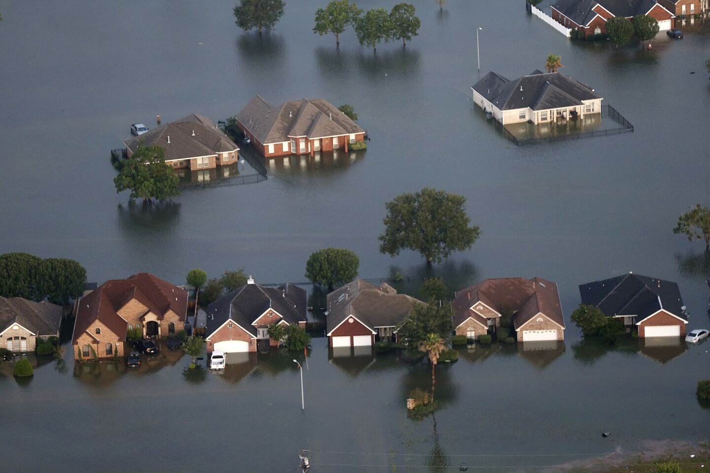 Floodwaters surround homes Thursday in Port Arthur, Texas.