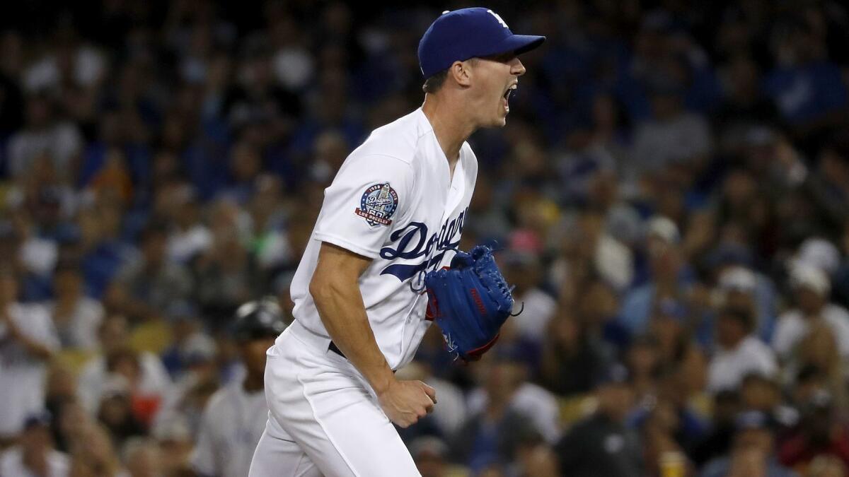 Dodgers rookie pitcher Walker Buehler celebrates after getting his 12th strikeout against the Rockies on Sept. 19.