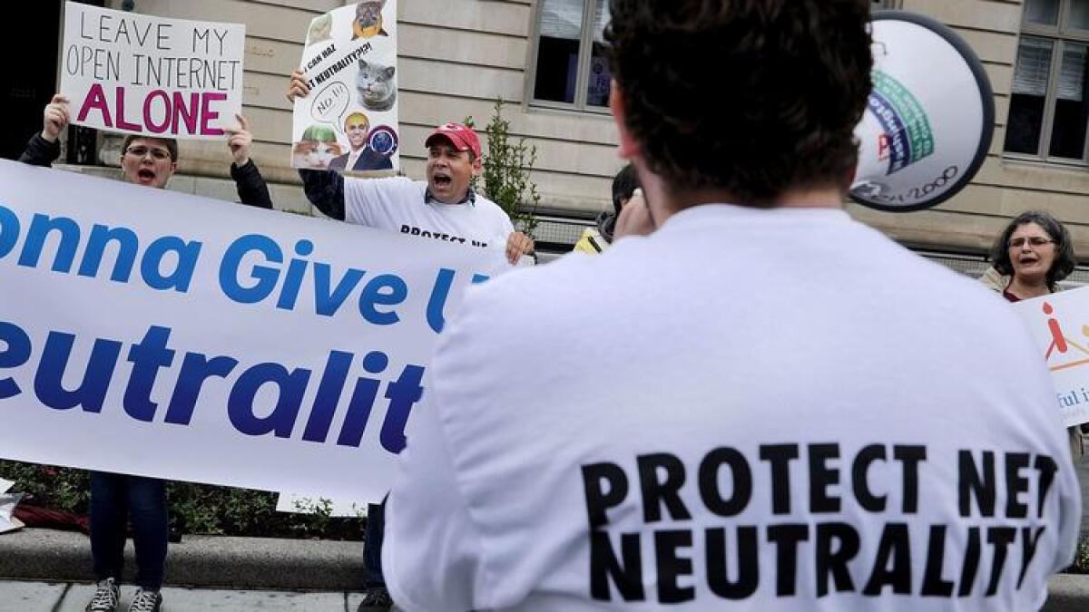 Proponents of net neutrality protest against Federal Communication Commission Chairman Ajit Pai in Washington.