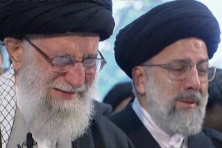 Iranian Supreme Leader Ayatollah Ali Khamenei, left, weeps as he leads a prayer over the coffin of Gen. Qassem Soleimani in Tehran on Monday.