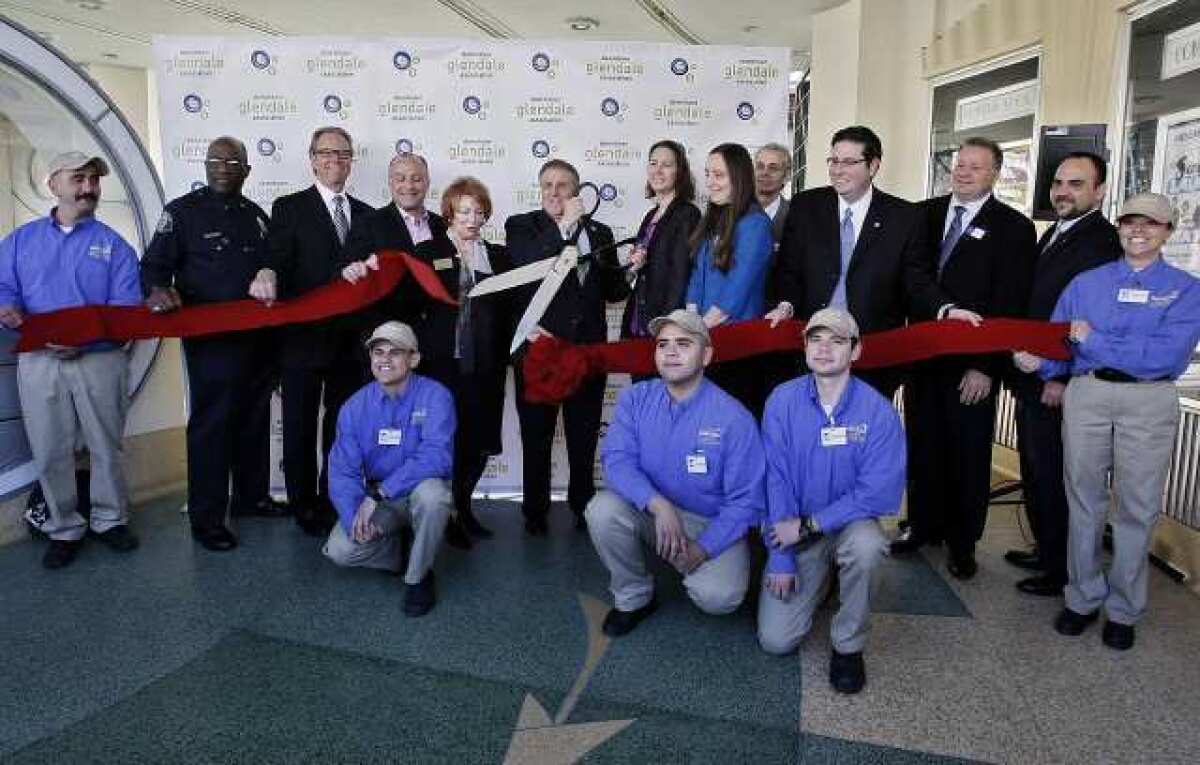 With city officials and members of the Downtown Glendale Association present at the Alex Theater in Glendale, DGA president Rick Lemmo cut the ribbon for the newly formed "Ambassadors" group. The ambassadors will roam downtown helping visitors with directions and information, and to help keep the city clean.