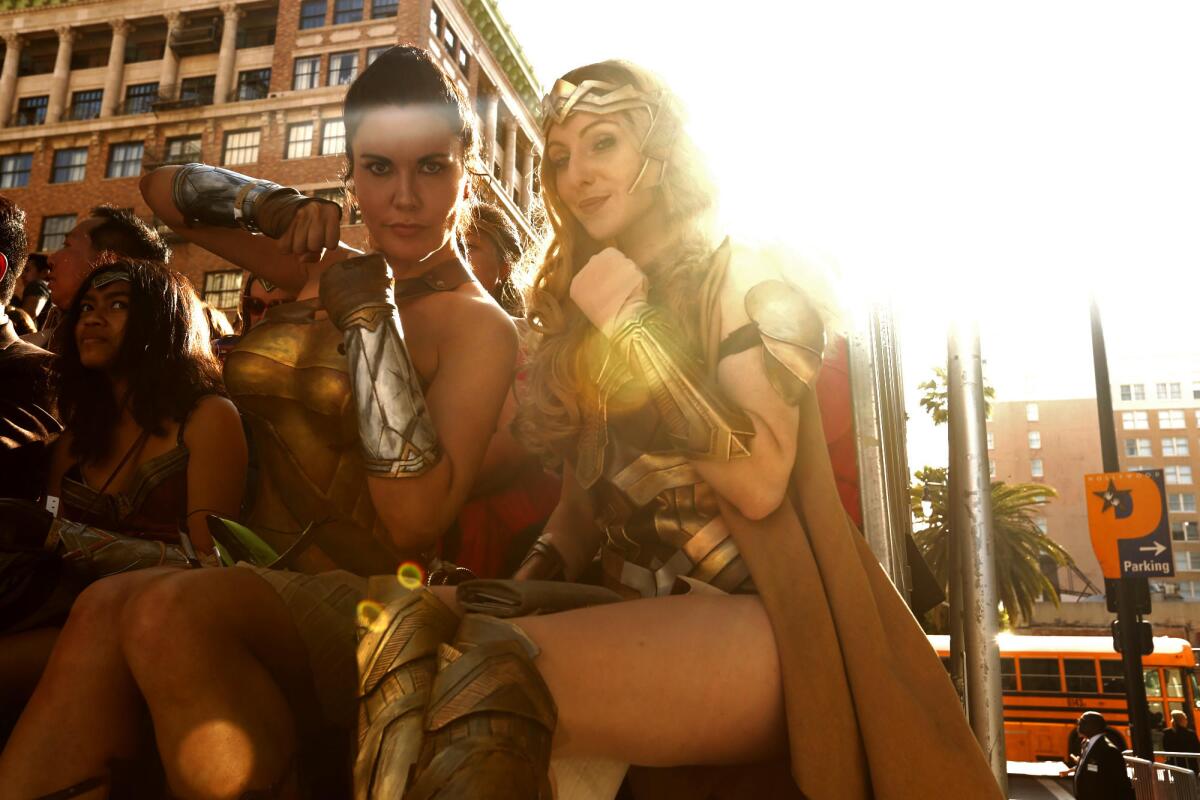 Victoria Ikerd from San Diego, left, and Sylvia Vale from Culver City strike their best Wonder Woman pose.