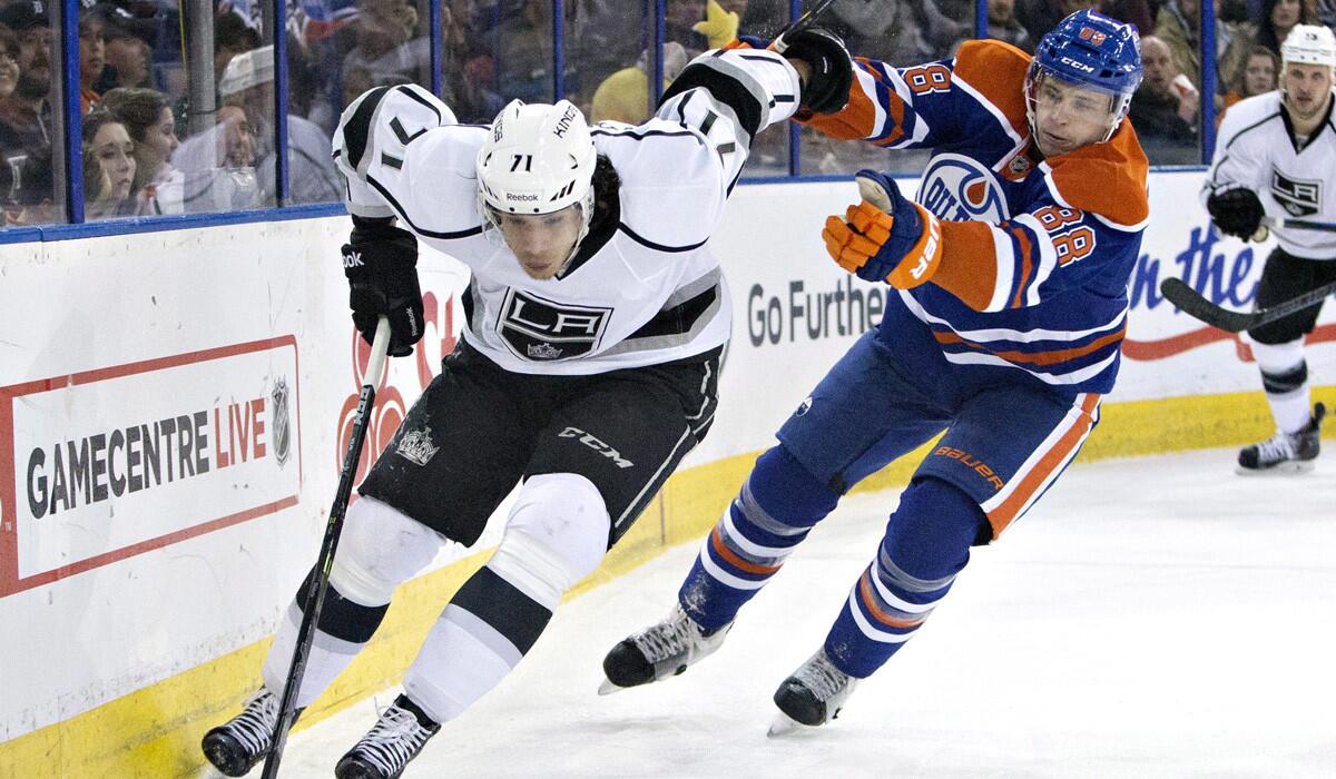 Kings' Jordan Nolan is chased by Oilers' Brandon Davidson during the Kings' 4-2 loss to the Oilers on Tuesday.