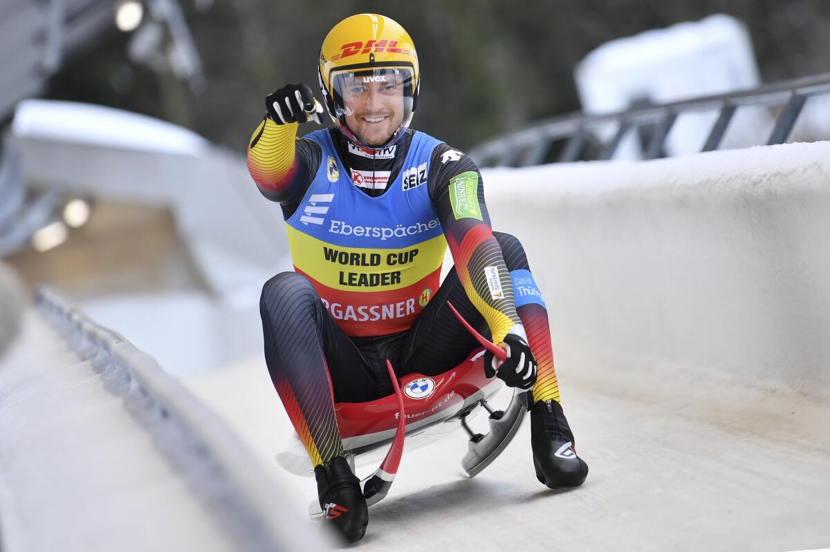 Johannes Ludwig from Germany cheers at the finish line of the men's single-seater event in Oberhof, Germany, Saturday, Jan.15, 2022. (Martin Schutt/dpa via AP)
