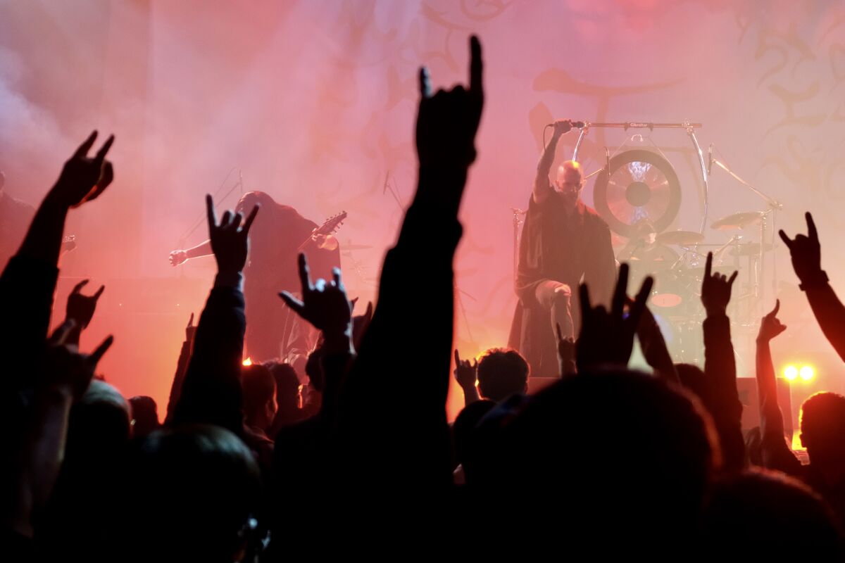 Joe Henley, right, lead vocalist of Taiwanese death metal band Dharma, performs during a concert in Taichung.