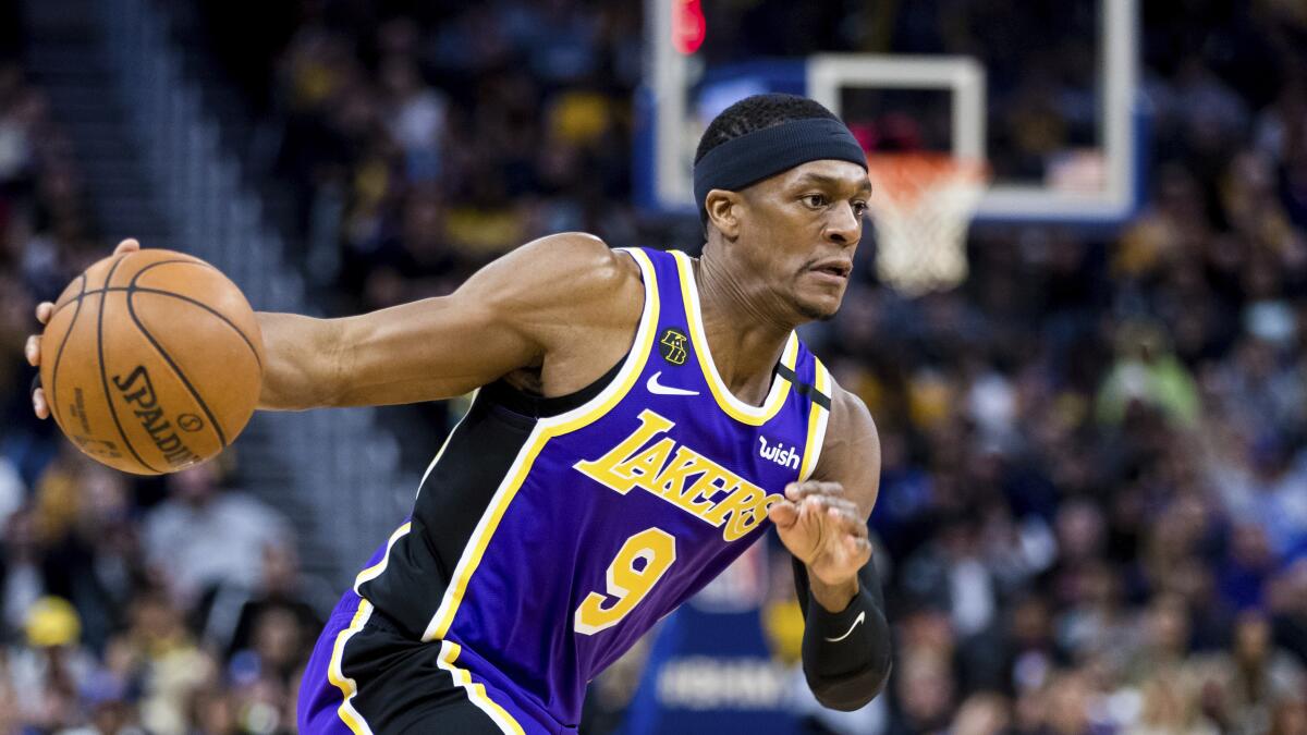 Lakers guard Rajon Rondo drives to the basket during a game.