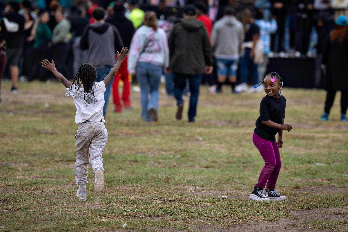Children enjoy a festive day at Nickerson Gardens as they wait for Top Dawg Entertainment's event to begin  Tuesday  in Los Angeles.