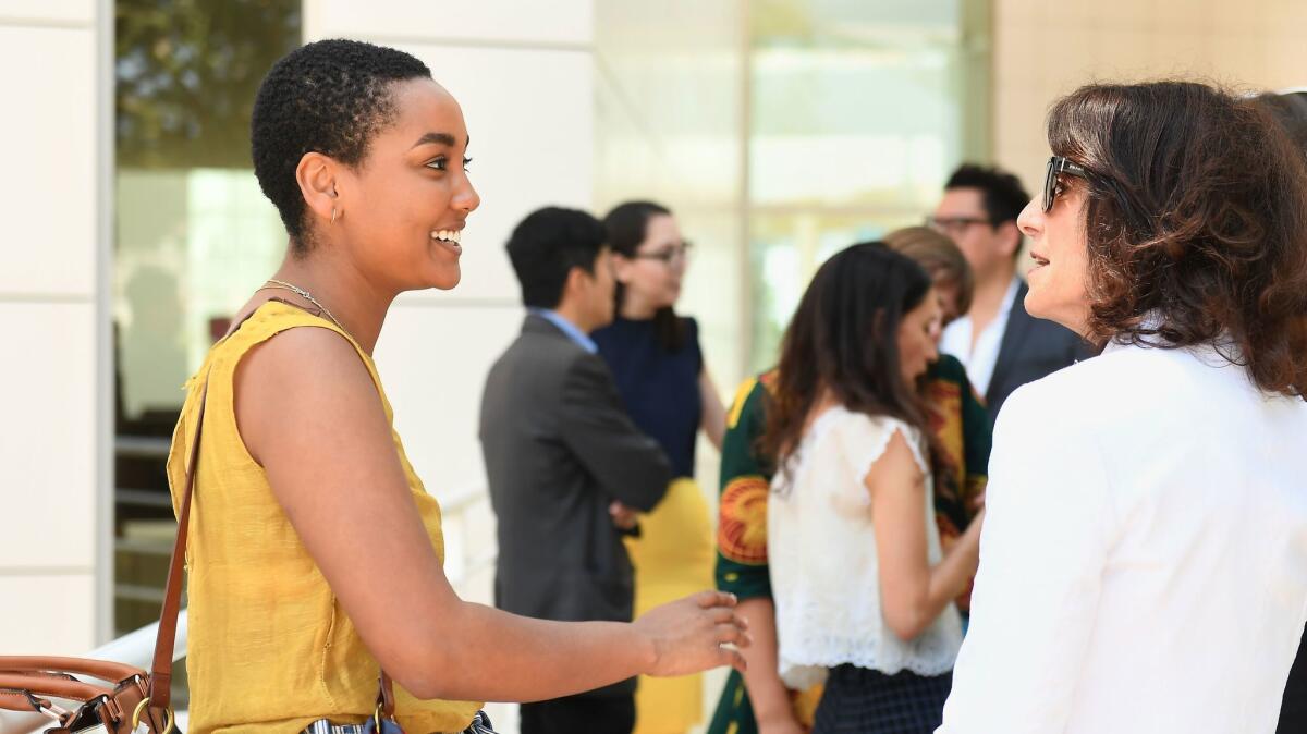 Joan Weinstein, deputy director of Getty Foundation, right, chats with Multicultural Internship alumna Hanna Girma, left, now an assistant curator at the Mistake Room.