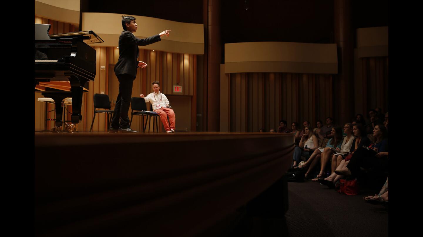 Peter Sellars watches onstage as Mishael Eusebio sings "The Boatman's Dance" during a master class at SongFest at the Colburn School. Few directors have had such a positive influence on singers as Sellars.