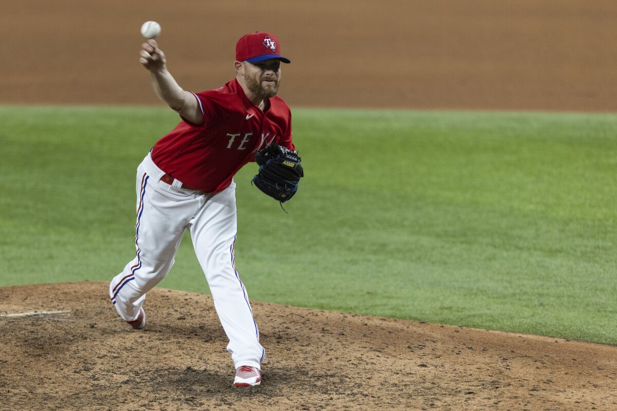 Texas Rangers relief pitcher Ian Kennedy throws during the ninth inning of the team's baseball game against the Tampa Bay Rays in Arlington, Texas, Friday, June 4, 2021. (AP Photo/Andy Jacobsohn)