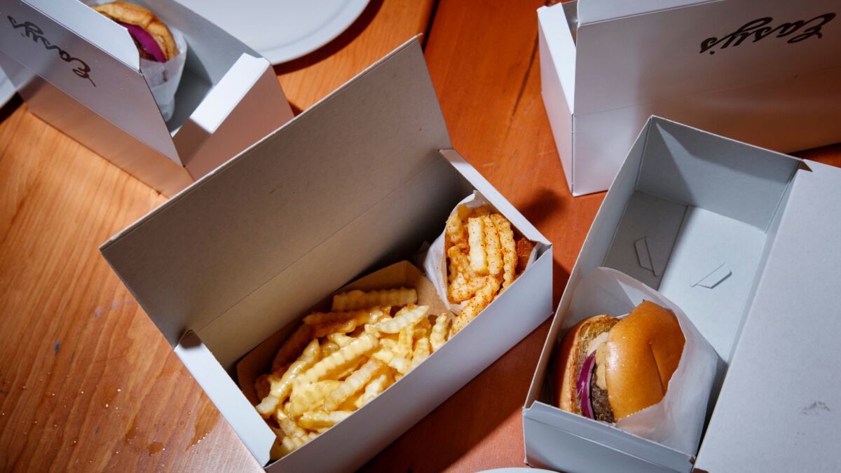 Hamburgers and fries, in custom boxes, at Easy's in Chinatown.