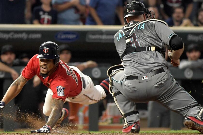 The Minnesota Twins' Byron Buxton slides safely into home plate with an inside-the-park home run as Arizona Diamondbacks catcher Chris Iannetta (8) takes the throw in the fourth inning on Friday, Aug. 18, 2017, at Target Field in Minneapolis. (Aaron Lavinsky/Minneapolis Star Tribune/TNS) ** OUTS - ELSENT, FPG, TCN - OUTS **
