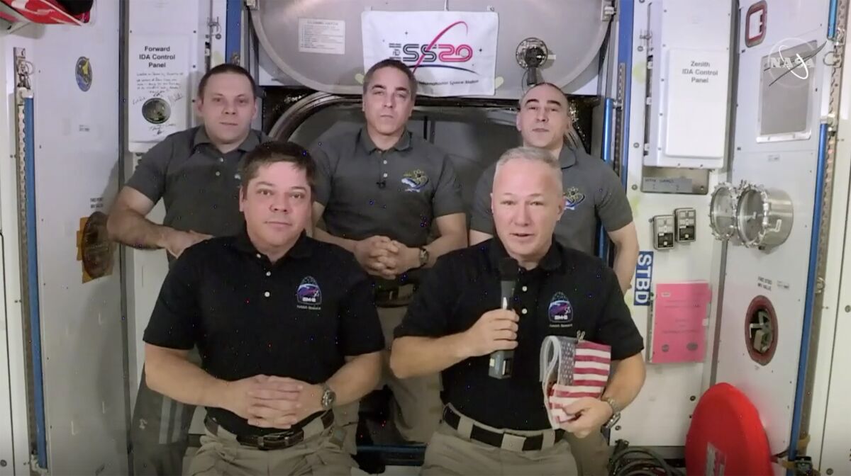 This photo provided by NASA shows, from left, front, astronauts Bob Behnken and Doug Hurley during an interview on the International Space Station on Saturday, Aug. 1, 2020. Behnken and Hurley are scheduled to leave the International Space Station in a SpaceX capsule on Saturday and splashdown off the coast of Florida on Sunday. (NASA via AP)