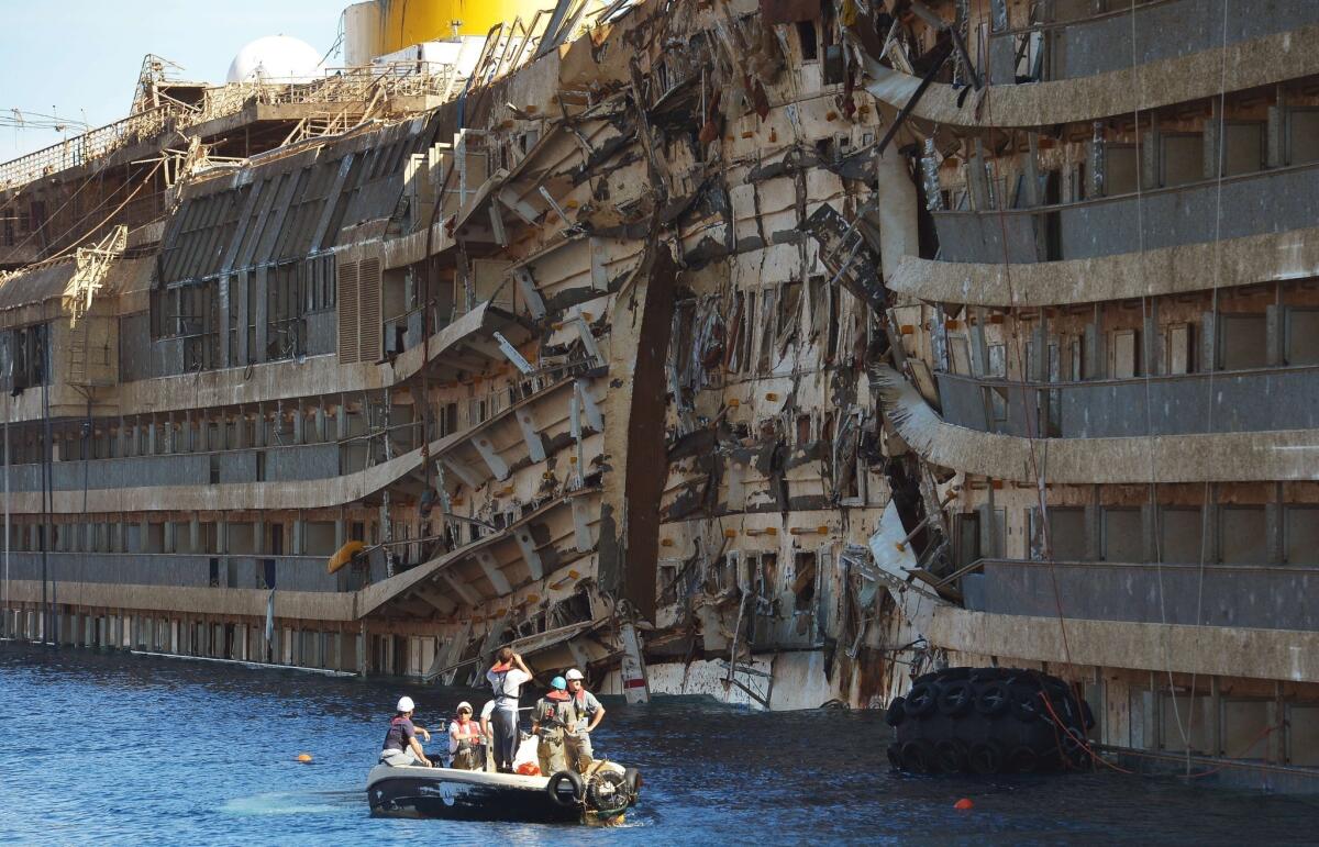 Salvage workers inspect the wreckage of the Costa Concordia cruise ship after it was raised from the water off the Italian coast.