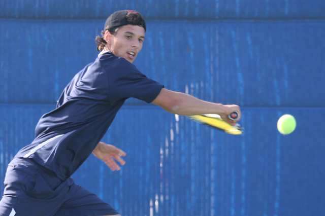 Newport Harbor's Jason Cernius chases down a shot during Thursday's Battle of the Bay tennis match between Corona del Mar and Newport Harbor.