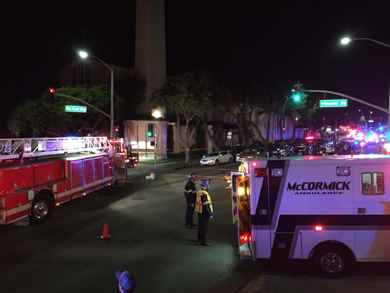 Paramedics respond after several people are injured Wednesday night when a car plowed into a crowd in Redondo Beach at Pacific Coast Highway and Vincent Street.