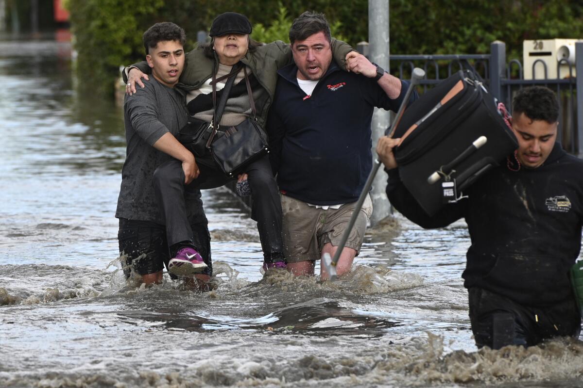 Woman being rescued from floodwaters