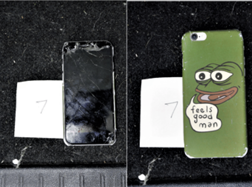 A smashed cellphone found in a raid that FBI agents believe belonged to UCLA student Christian Secor.