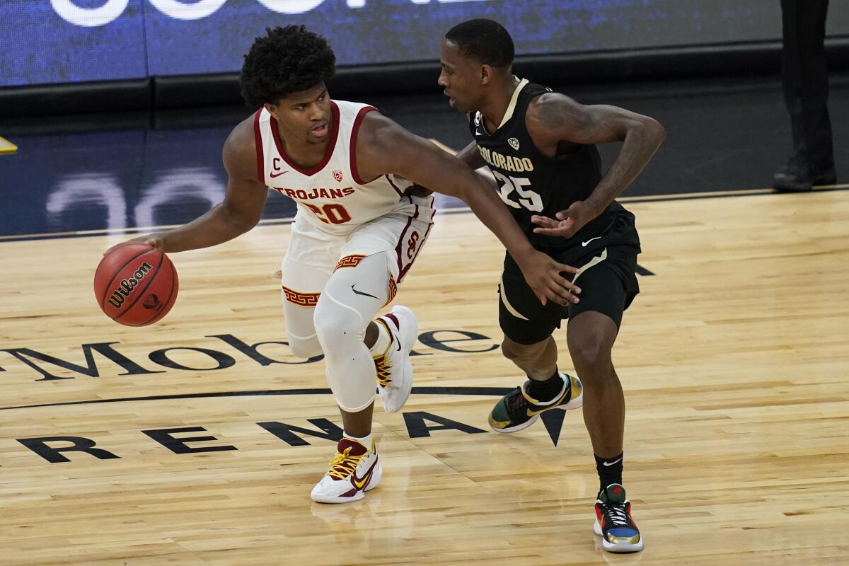 USC's Ethan Anderson controls the ball in front of Colorado's McKinley Wright.