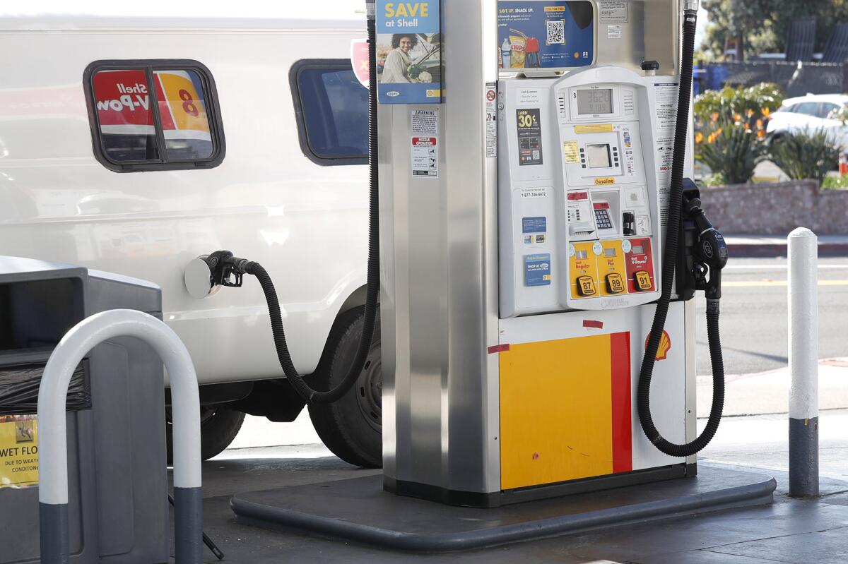 A van is fueled up at a Shell station in Laguna Beach on Monday.