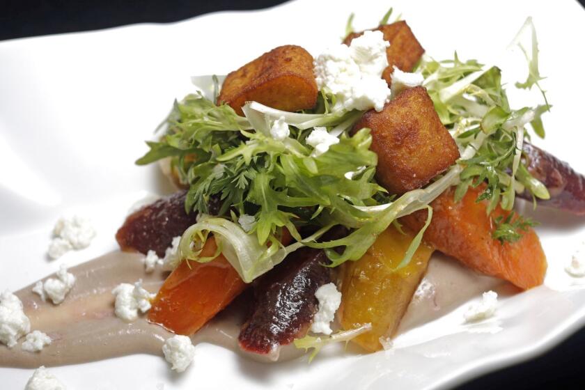 LOS ANGELES ? APRIL 5, 2018: Los Angeles Times Recipe Tester Julie Giuffrida's rendition of Chef Curtis Gamble's carrot salad with pomegranate curd, fresh cheese, chickpea fritters, bitter greens and harissa vinaigrette. Curtis serves the salad at his Pittsburgh restaurant where L.A. Times reader Linda Doan tasted it and requested the Times to help re-create it. (Calvin B. Alagot / Los Angeles Times)