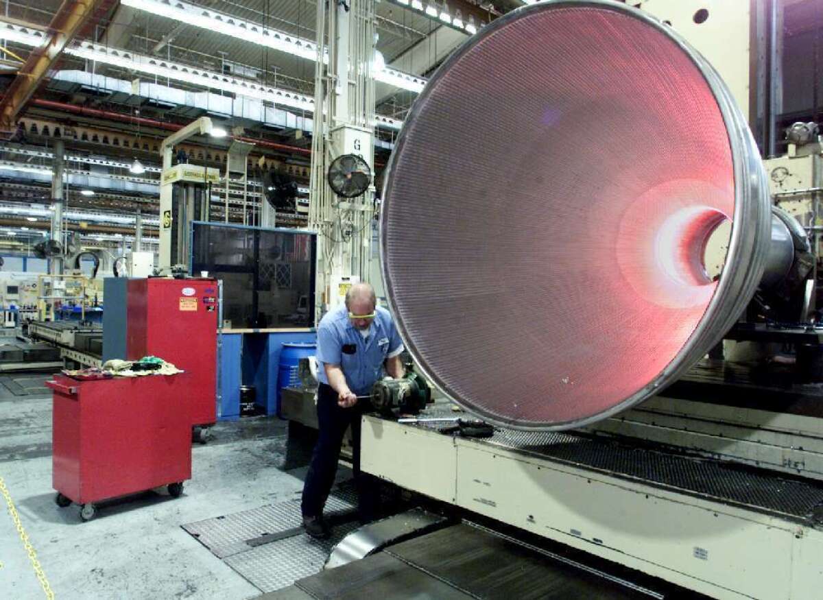 A Rocketdyne employee works on the nozzle of a Delta Rocket at the Canoga Park facility.
