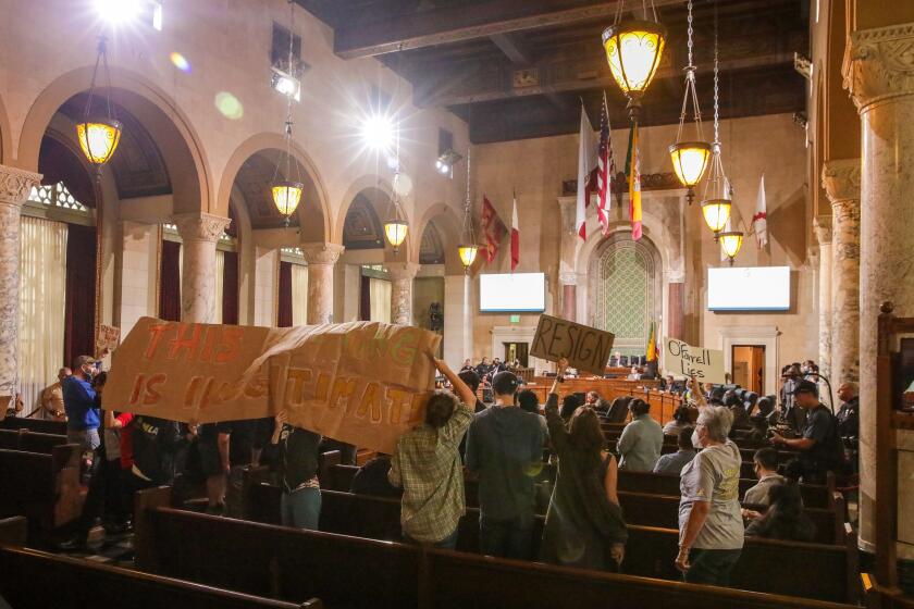 Los Angeles, CA - October 26: Protestors demanding resignations, disrupt city council meeting held to censure Councilmen Kevin de Leon and Gil Cedillo and former Councilwoman Nury Martinez for their racist comments inn audio leak. City Hall on Wednesday, Oct. 26, 2022 in Los Angeles, CA. (Irfan Khan / Los Angeles Times)