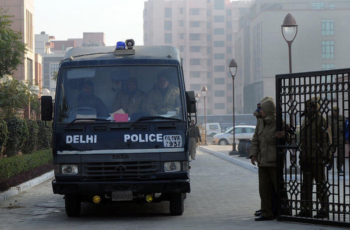 Indian police personnel escort a prisoner transport vehicle after the men accused in a gang rape and murder case were presented in Saket District Court in New Delhi.
